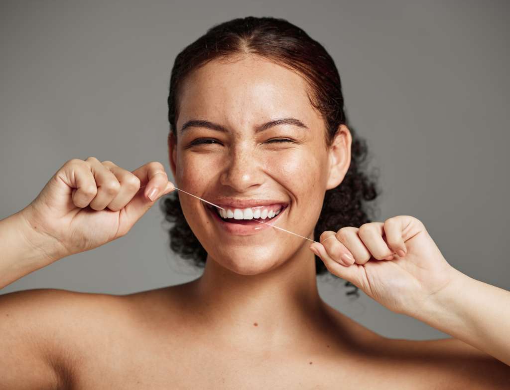 Woman flossing between her teeth