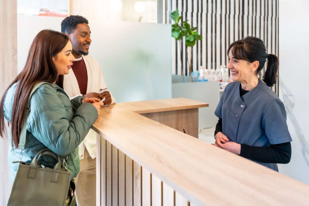 Patients being welcomed at the practice reception desk
