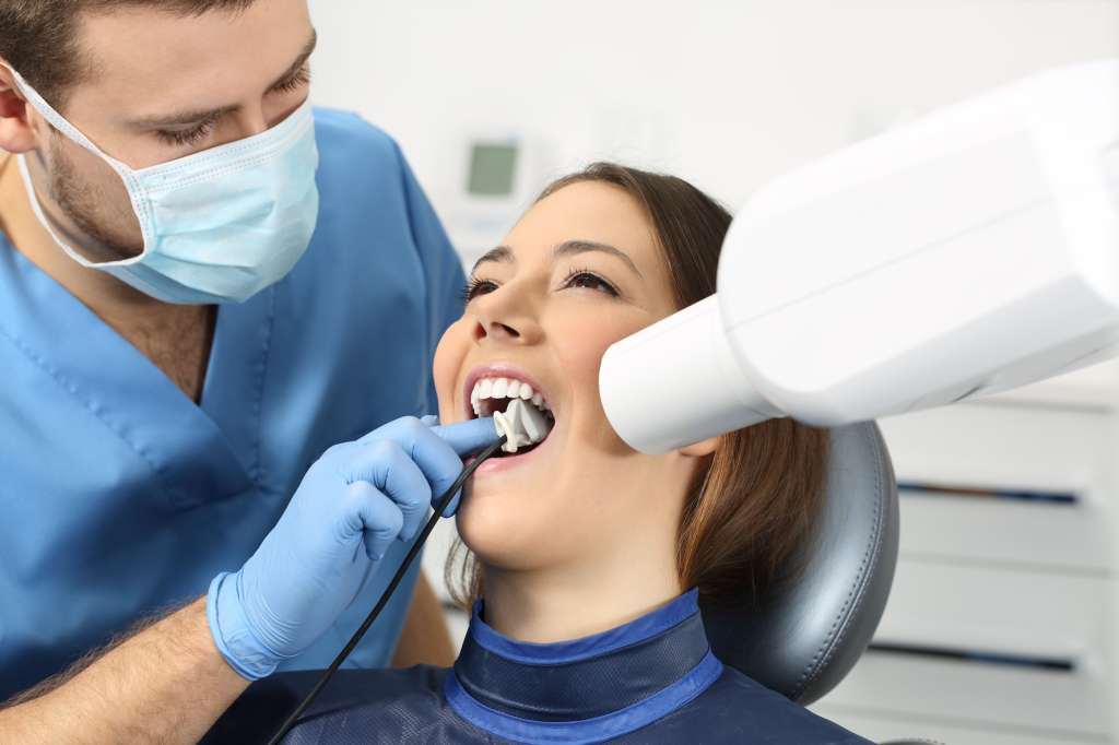 Dentist using an intraoral scanner to take a digital impression